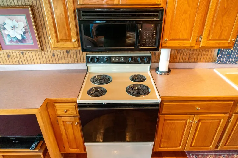 Slide: The Image of Kitchen interior of 1995 Lakeview houseboat with stove and microwave. - 29