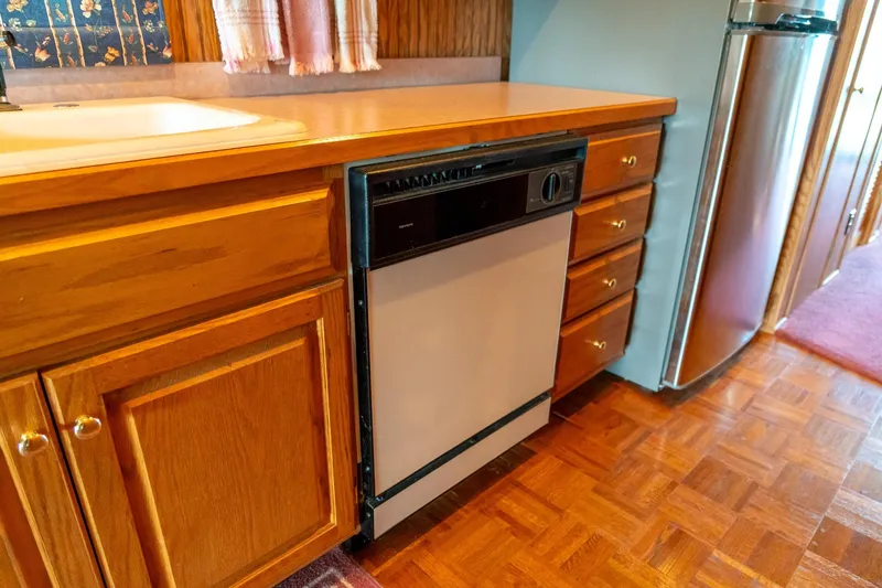 Slide: The Image of Kitchen area of 1995 Lakeview houseboat with wooden cabinets and dishwasher. - 30