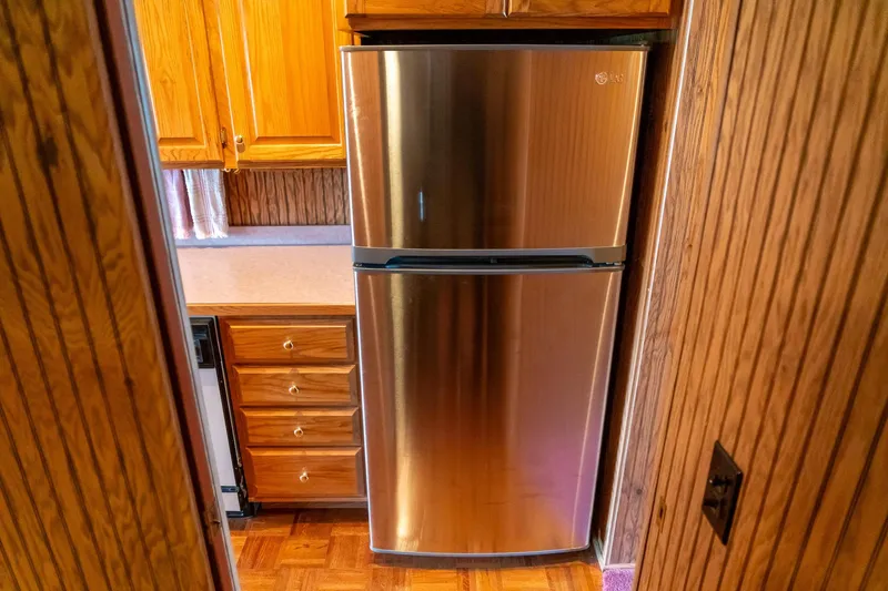 Slide: The Image of Stainless steel refrigerator in a 1995 Lakeview 62 x 14 Widebody Houseboat kitchen. - 31
