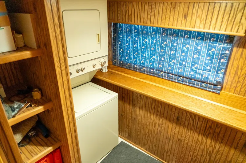Slide: The Image of Laundry area in 1995 Lakeview 62 x 14 Widebody Houseboat with wood paneling and blue curtains. - 35