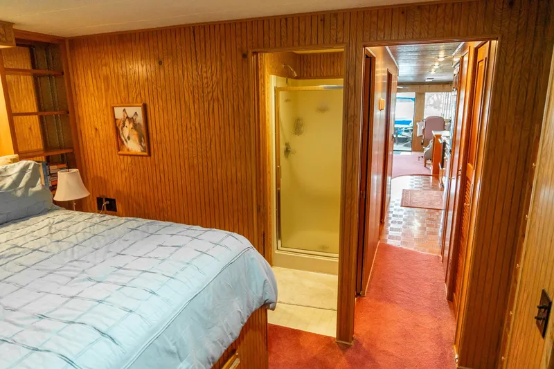 Slide: The Image of Cozy bedroom and hallway in 1995 Lakeview 62 x 14 Widebody Houseboat. - 37