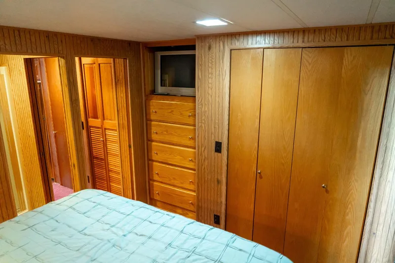 Slide: The Image of Interior of 1995 Lakeview houseboat bedroom with wood paneling and built-in storage. - 38