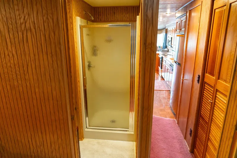 Slide: The Image of Interior of 1995 Lakeview 62 x 14 Widebody Houseboat with shower and wooden cabinetry. - 39