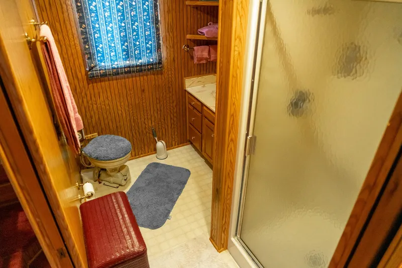 Slide: The Image of Bathroom interior of 1995 Lakeview houseboat with wood paneling and shower. - 40