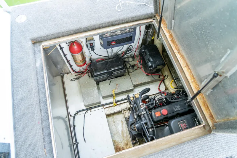 Slide: The Image of Engine compartment of a 1995 Lakeview 62 x 14 Widebody Houseboat, featuring batteries and fire extinguisher. - 47