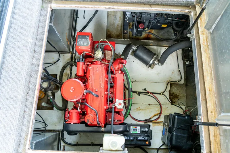 Slide: The Image of Engine compartment of 1995 Lakeview 62 x 14 Widebody Houseboat, featuring red engine components. - 50
