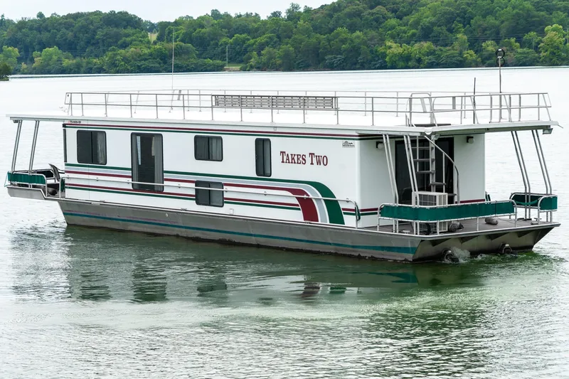 Slide: The Image of 1995 Lakeview 62 x 14 Widebody Houseboat on a serene lake. - 6