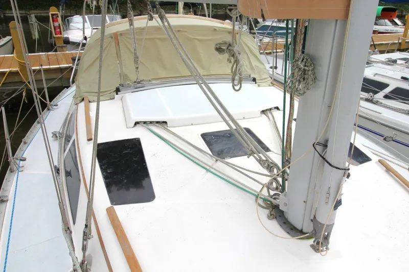 Slide: The Image of 1989 Hunter Legend 35.5 sailboat deck with rigging and canopy in marina. - 11