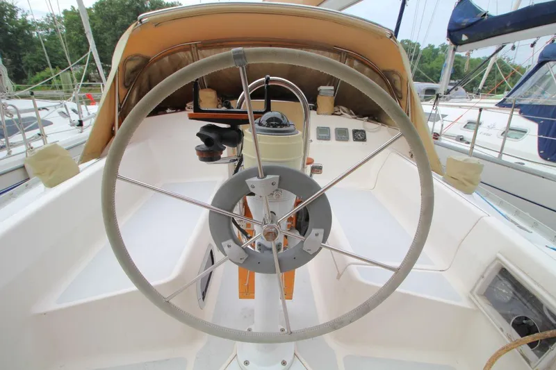 Slide: The Image of Cockpit of 1989 Hunter Legend 35.5 sailboat with steering wheel and navigation instruments. - 12