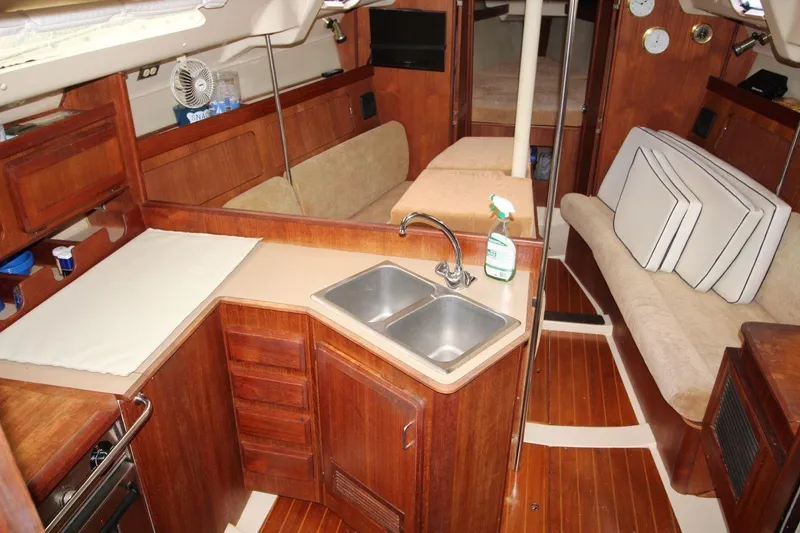 Slide: The Image of Interior of 1989 Hunter Legend 35.5 sailboat with wooden cabinetry and compact kitchen. - 14