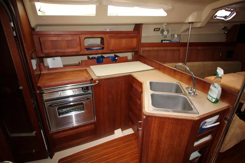 Slide: The Image of 1989 Hunter Legend 35.5 yacht kitchen with wood cabinetry, dual sinks, and stainless steel oven. - 15