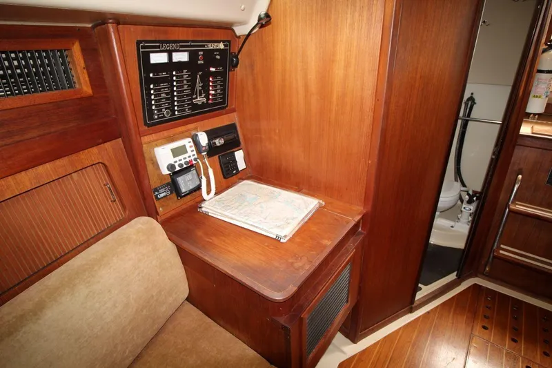 Slide: The Image of Navigation station in 1989 Hunter Legend 35.5 sailboat with control panel and communication equipment. - 16