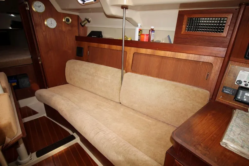 Slide: The Image of Interior of 1989 Hunter Legend 35.5 sailboat with beige seating and wooden accents. - 17