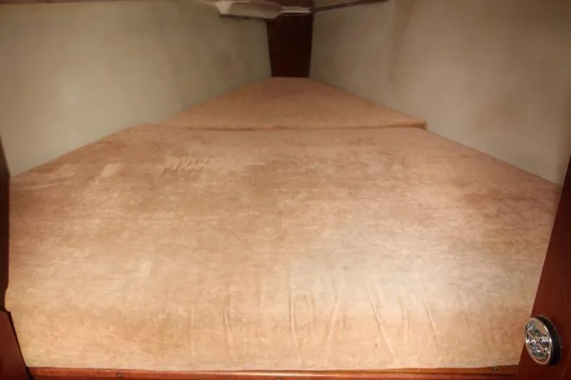 Slide: The Image of Interior cabin of 1989 Hunter Legend 35.5 sailboat with beige bedding. - 19