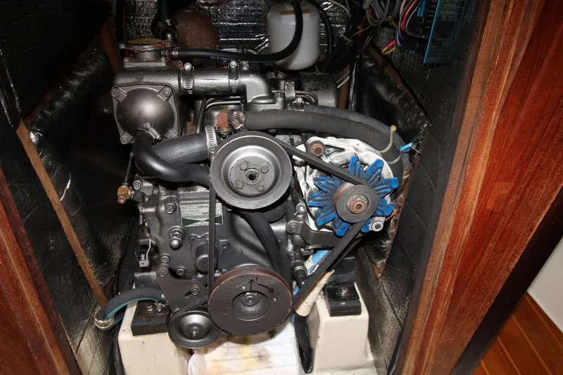 Slide: The Image of Engine compartment of a 1989 Hunter Legend 35.5 sailboat, showcasing mechanical components. - 23