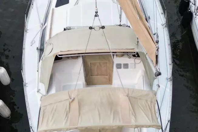 Slide: The Image of 1989 Hunter Legend 35.5 sailboat with beige canopy, docked in marina. - 5