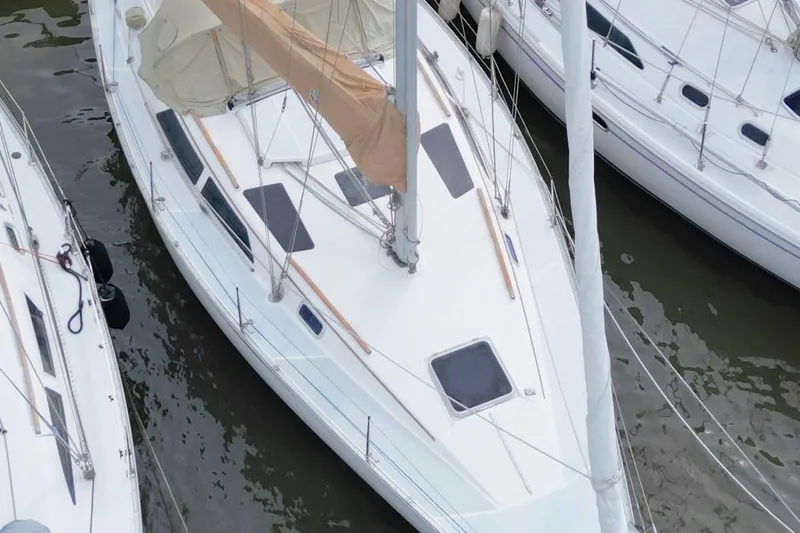 Slide: The Image of 1989 Hunter Legend 35.5 sailboat docked among other boats. - 7