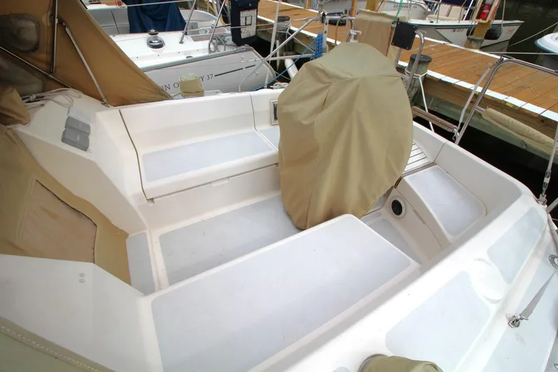 Slide: The Image of Cockpit of 1989 Hunter Legend 35.5 sailboat with beige covers and seating. - 9