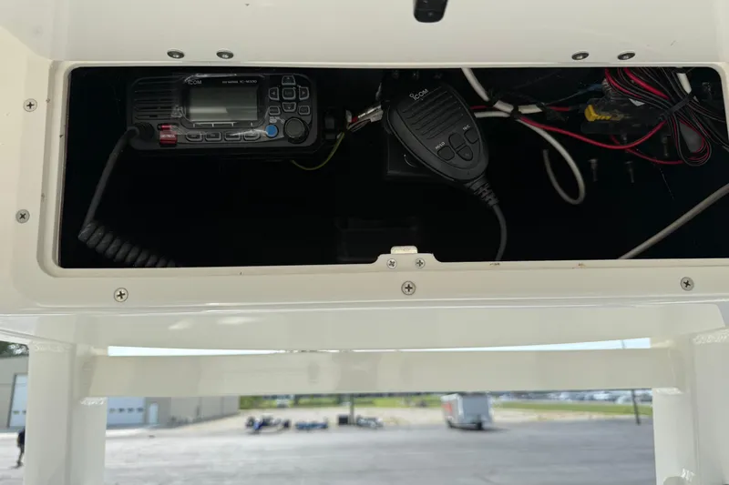 Slide: The Image of 2023 NauticStar 24 XS boat radio and wiring compartment. - 10