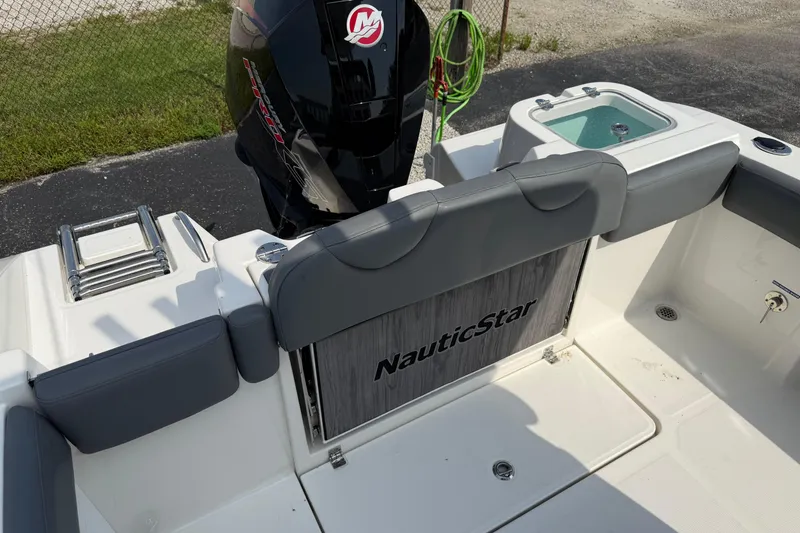 Slide: The Image of 2023 NauticStar 24 XS boat interior with motor and seating area. - 8