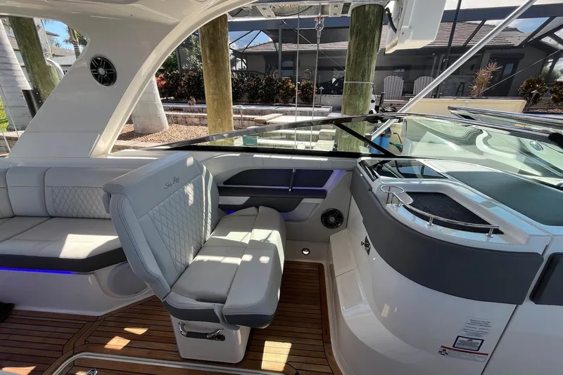 Slide: The Image of 2022 Sea Ray SLX 310 Outboard interior with luxurious seating and modern design. - 13