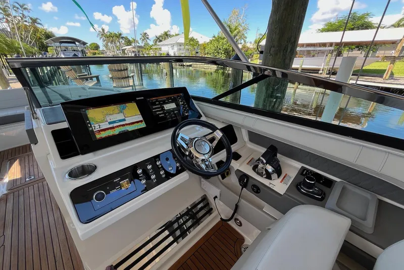 Slide: The Image of 2022 Sea Ray SLX 310 Outboard helm with advanced navigation system and luxurious interior. - 14