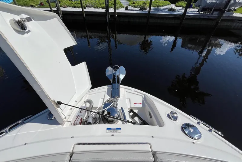 Slide: The Image of 2022 Sea Ray SLX 310 Outboard bow with anchor storage, docked by calm water. - 27
