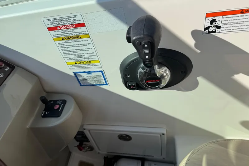 Slide: The Image of Control panel of a 2012 Sea Ray 280 Sundancer boat with safety warnings. - 14