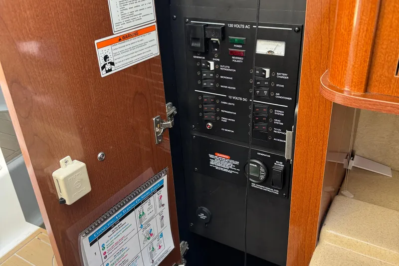 Slide: The Image of Electrical control panel inside 2012 Sea Ray 280 Sundancer boat cabin. - 17