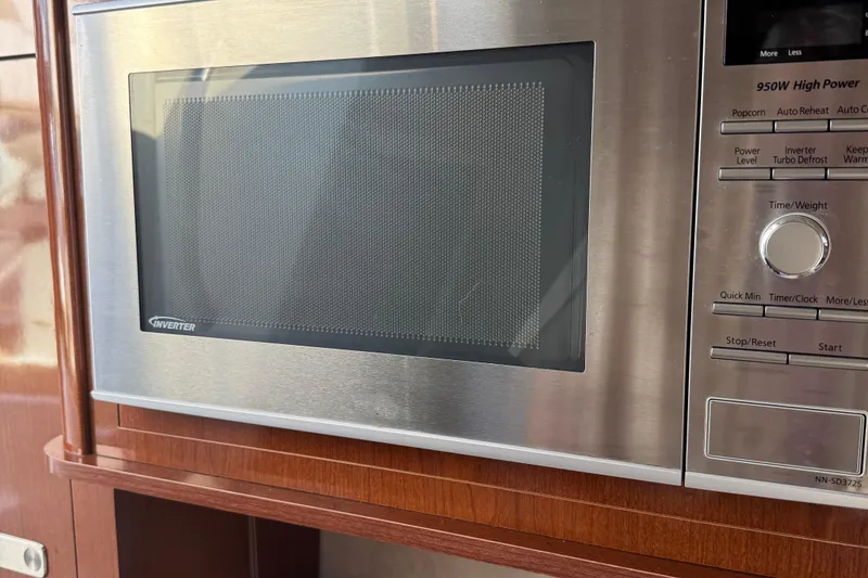 Slide: The Image of Microwave oven inside 2012 Sea Ray 280 Sundancer boat, featuring stainless steel finish. - 20