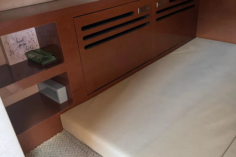 Slide: The Image of Interior of 2012 Sea Ray 280 Sundancer with wooden cabinetry and cushioned seating. - 22