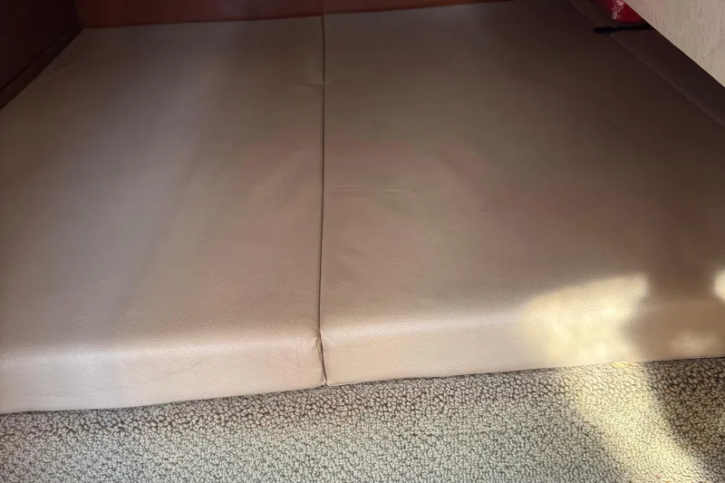 Slide: The Image of Interior cabin view of 2012 Sea Ray 280 Sundancer boat, featuring beige upholstery. - 23