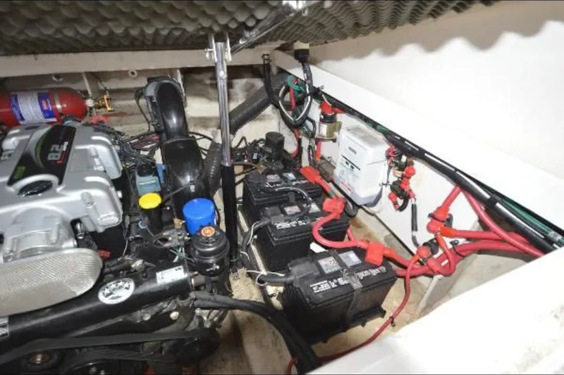 Slide: The Image of Engine compartment of a 2012 Sea Ray 280 Sundancer with visible batteries and wiring. - 28