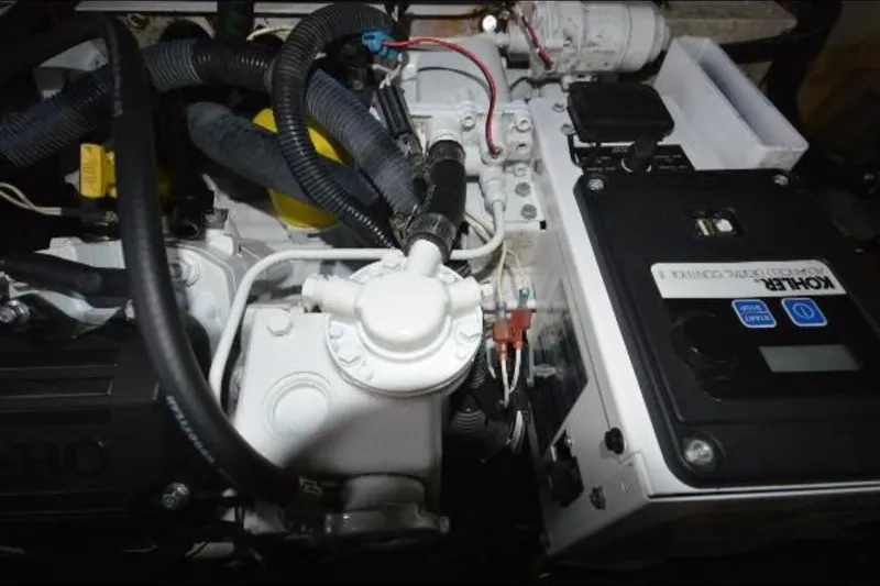 Slide: The Image of Engine compartment of a 2012 Sea Ray 280 Sundancer boat, featuring mechanical components. - 29
