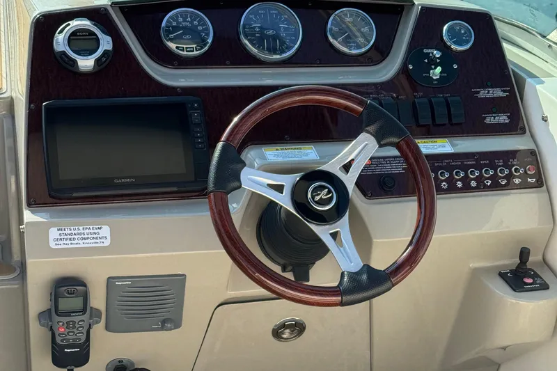 Slide: The Image of Steering console of 2012 Sea Ray 280 Sundancer with Garmin display and wood-trimmed wheel. - 5