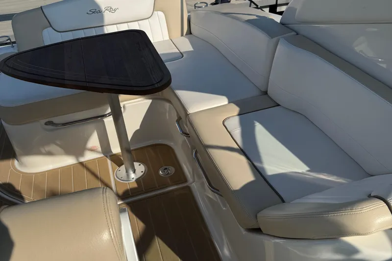 Slide: The Image of Interior seating of 2012 Sea Ray 280 Sundancer with table and cushioned seats. - 6