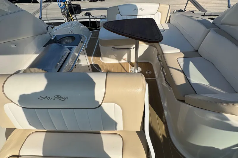 Slide: The Image of Interior of 2012 Sea Ray 280 Sundancer with seating and small table. - 7