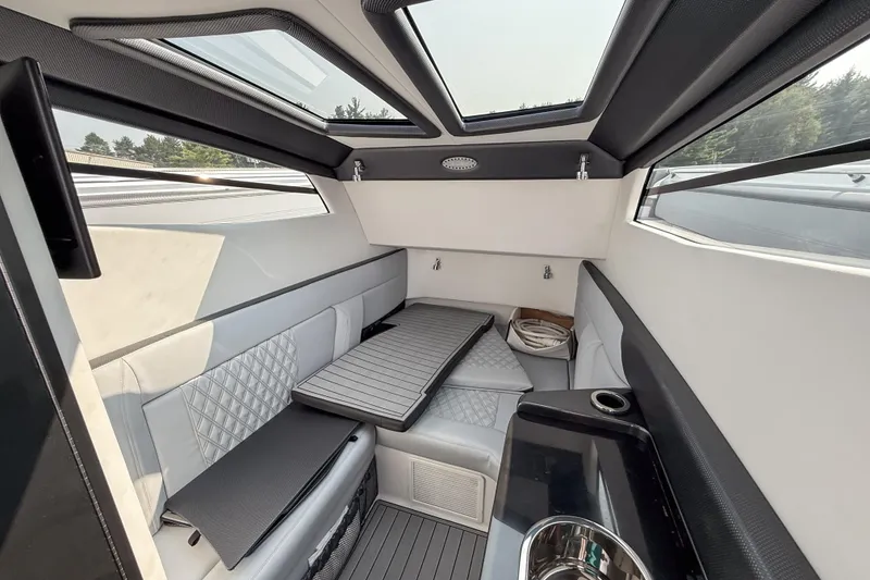 Slide: The Image of Interior of 2019 Nor-Tech 450 Sport Center Console with modern seating and skylights. - 12