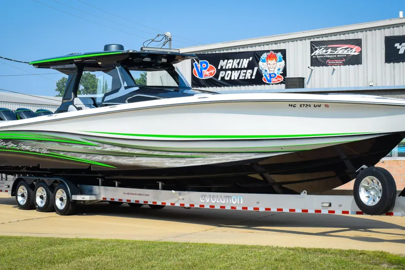 Slide: The Image of 2019 Nor-Tech 450 Sport Center Console boat on trailer, displayed outdoors. - 3