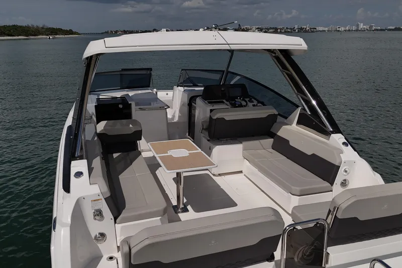 Slide: The Image of 2025 Aquila 32 Sport boat with spacious seating and modern design on calm waters. - 10
