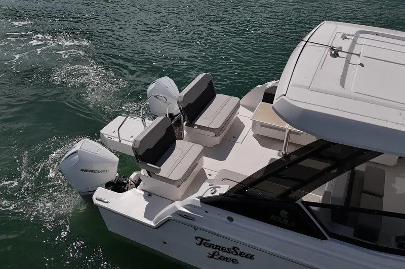 Slide: The Image of Aquila 32 Sport 2025 boat with Mercury engines on water. - 11