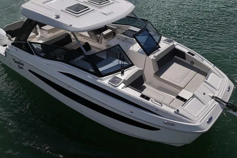 Slide: The Image of 2025 Aquila 32 Sport boat on water, featuring sleek design and spacious deck. - 12