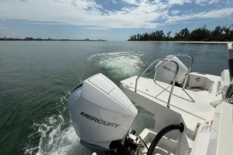 Slide: The Image of Aquila 32 Sport 2025 boat with Mercury engines cruising on a sunny day. - 15