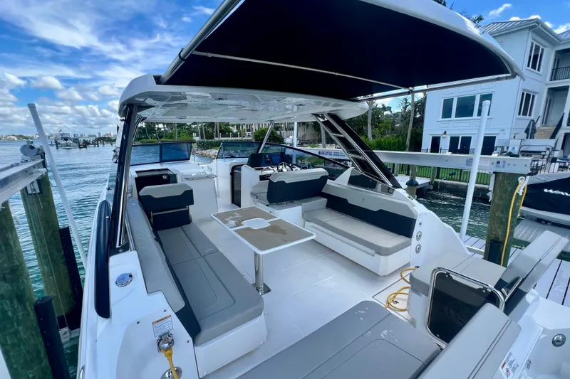 Slide: The Image of 2025 Aquila 32 Sport boat with spacious seating and modern design docked by waterfront. - 16