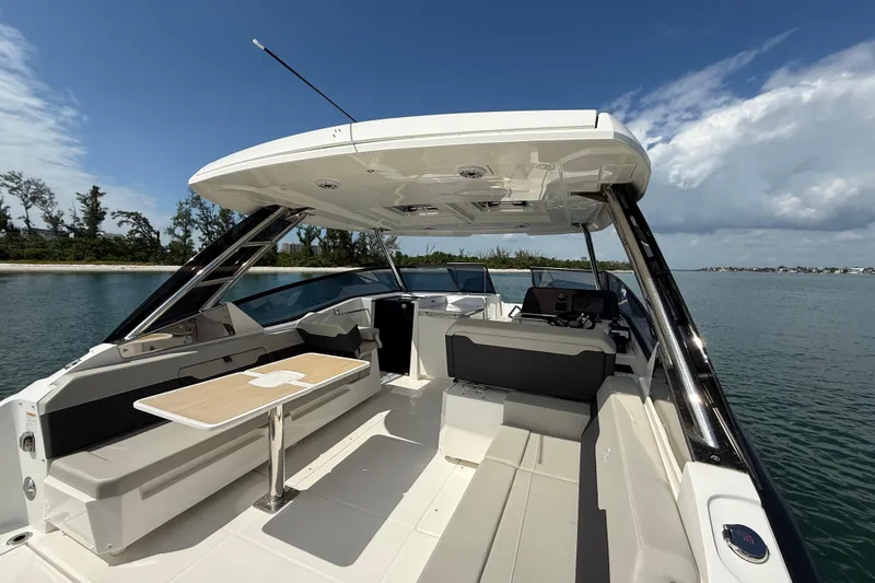 Slide: The Image of Aquila 32 Sport 2025 boat interior with seating and table on calm water. - 17