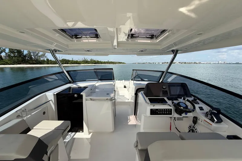 Slide: The Image of Interior view of 2025 Aquila 32 Sport boat, featuring modern helm and seating. - 24