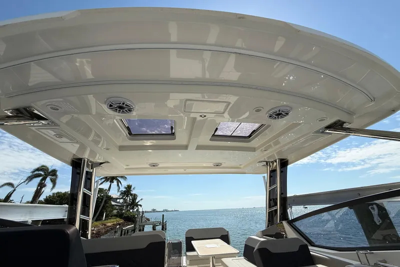 Slide: The Image of Aquila 32 Sport 2025 boat interior with ocean view, featuring a sleek roof design. - 26