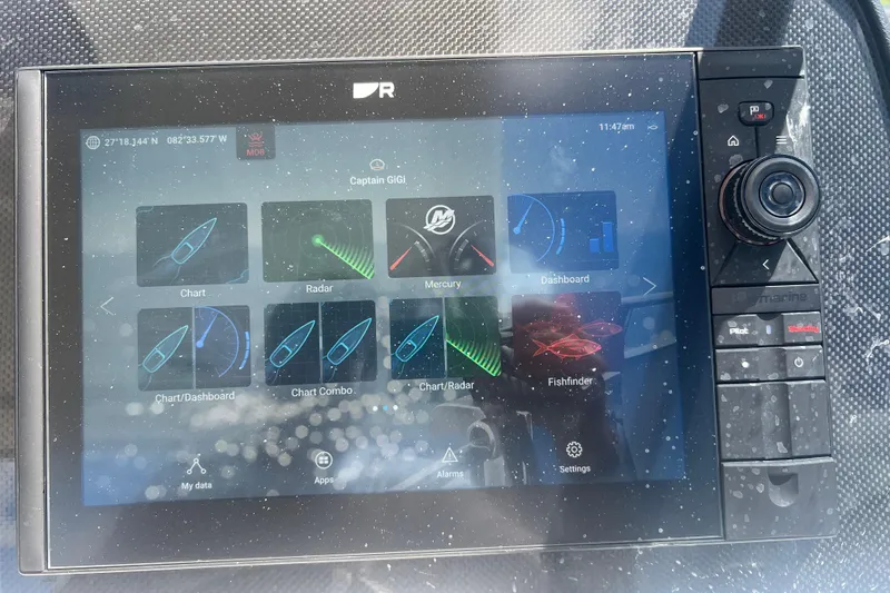 Slide: The Image of Touchscreen navigation system on 2025 Aquila 32 Sport boat displaying charts and radar. - 31