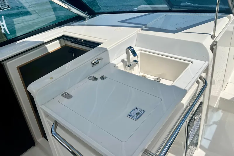 Slide: The Image of Aquila 32 Sport 2025 boat kitchenette with sink and storage compartments. - 33