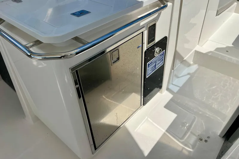 Slide: The Image of 2025 Aquila 32 Sport boat interior with stainless steel cabinet and sleek design. - 37